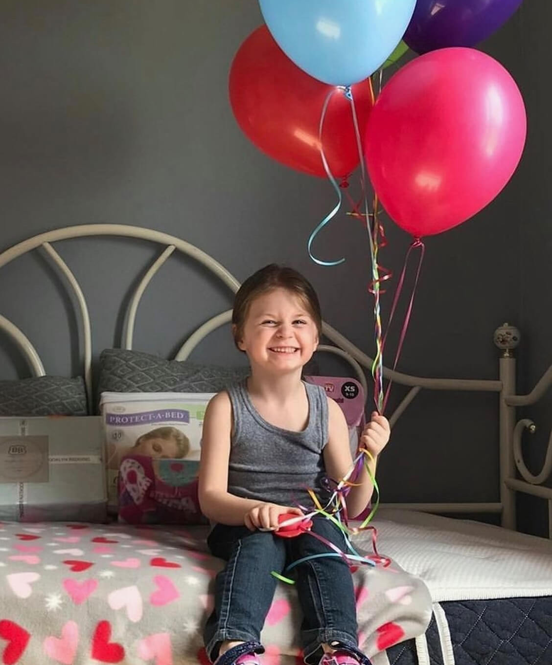 A Girl Holds Balloons and Feeling Happy