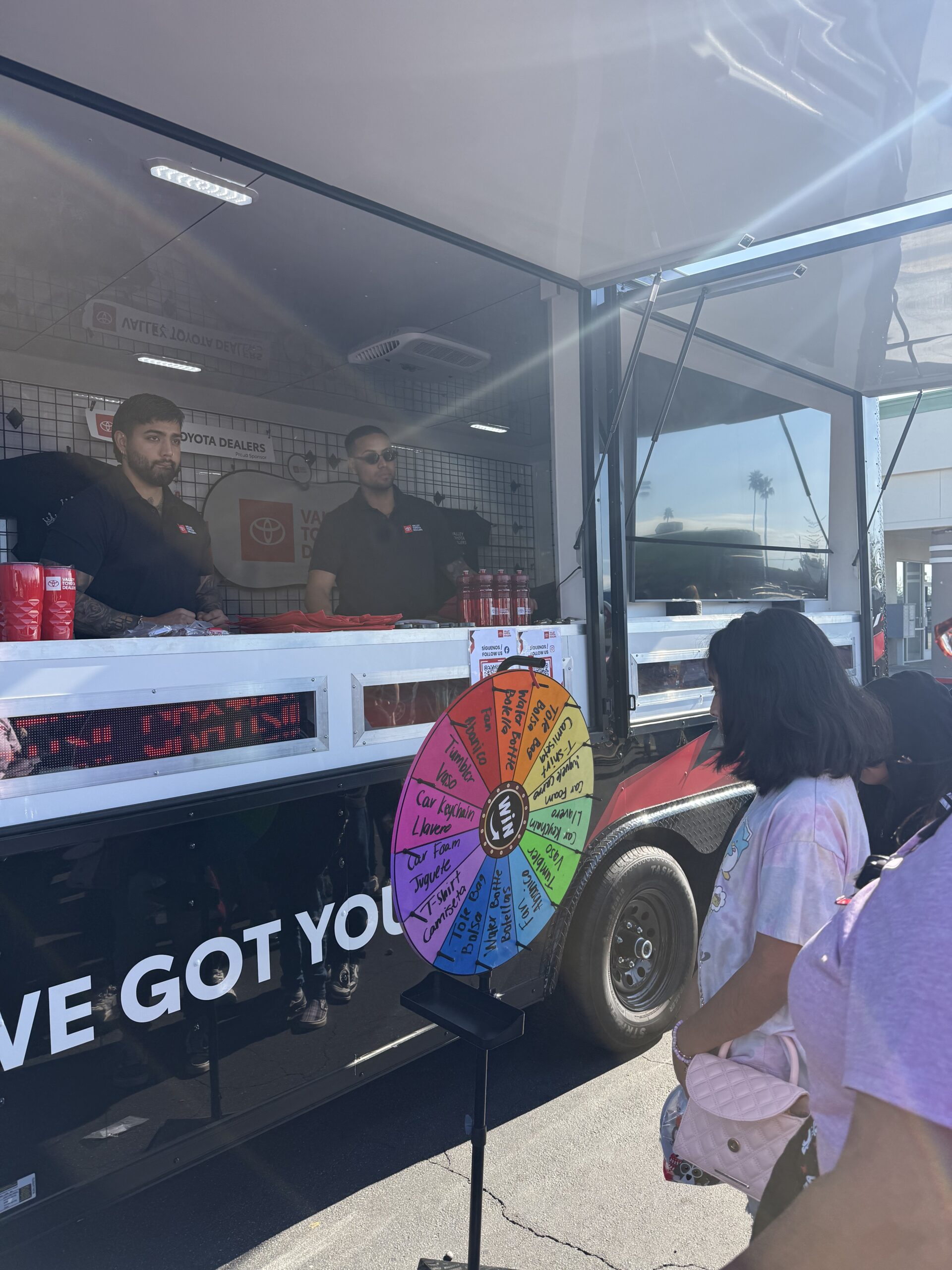 Girl spinning the wheel of fortune.