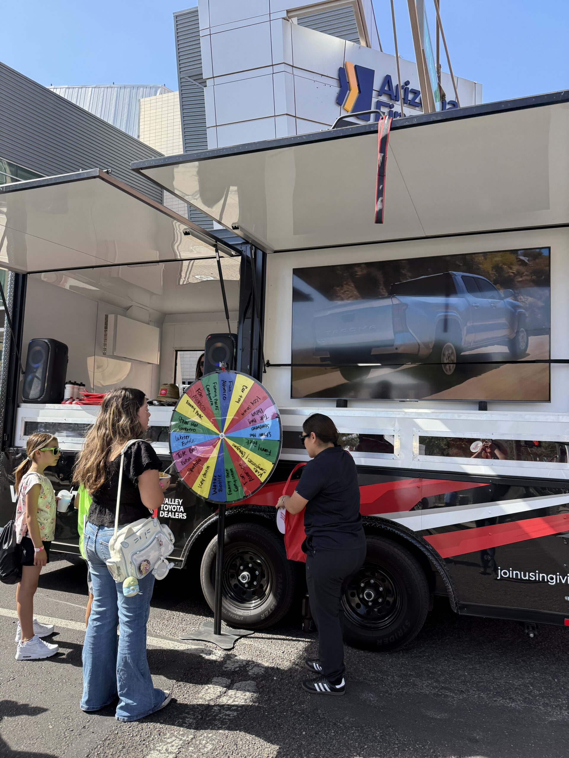 People interacting with spin the wheel